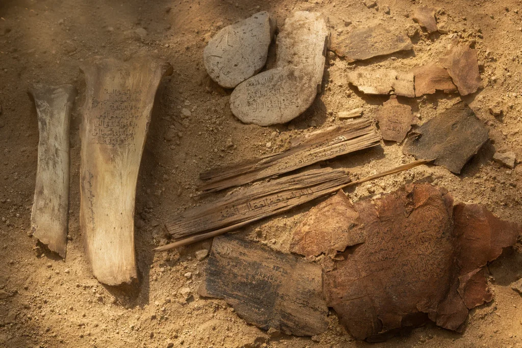 Ancient writing materials: bones, palm leaves, leather and stones with Quranic text